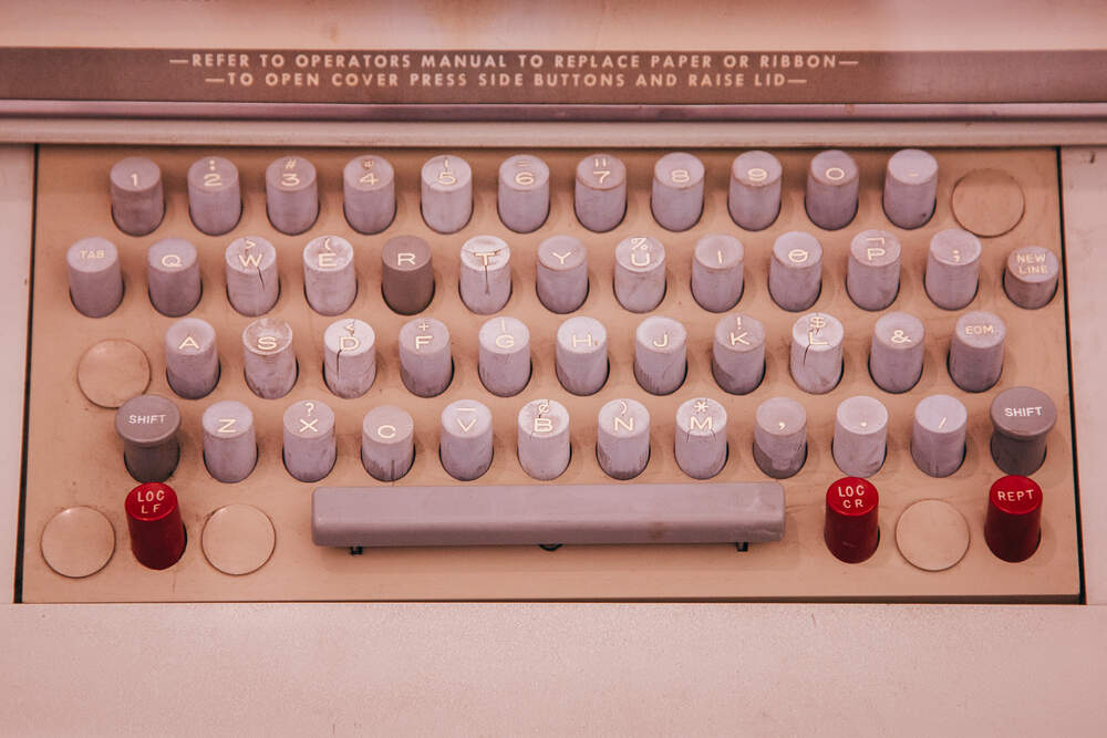 Teletype Model 35 from the 1960s, with a more complex setup – a <span class="key">New Line</span> and <span class="key">EOM</span> keys for remote communication, but also <span class="key">Loc LF</span> and <span class="key">Loc CR</span> for local operation. We’ll get back to this.